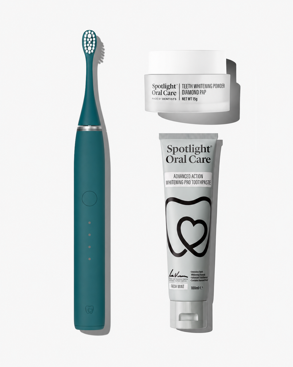 A dental care bundle featuring a teal electric toothbrush, a white tube of Spotlight Oral Care toothpaste, and a white jar of Spotlight Oral Care teeth whitening powder, arranged on a light gray background.