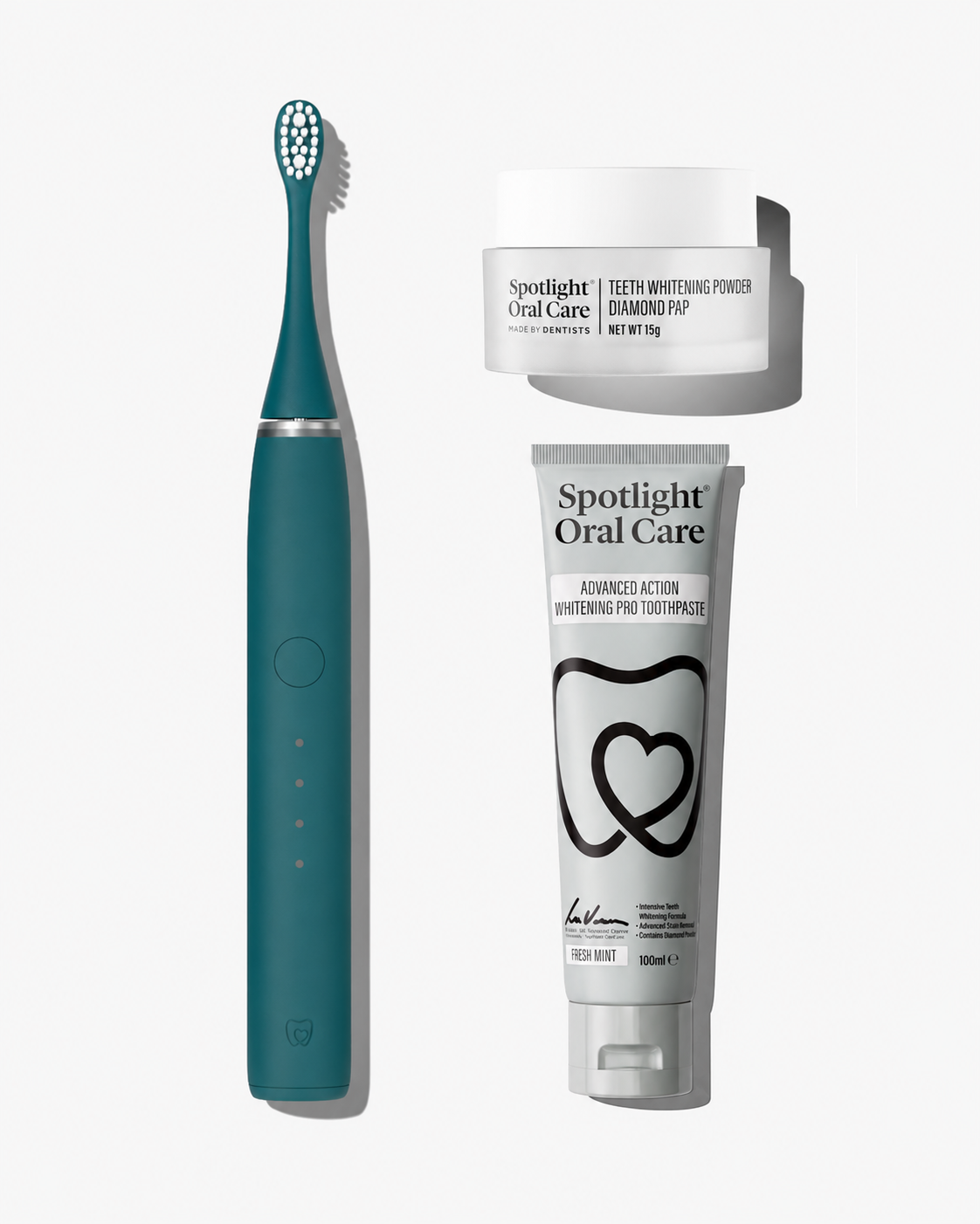 A dental care bundle featuring a teal electric toothbrush, a white tube of Spotlight Oral Care toothpaste, and a white jar of Spotlight Oral Care teeth whitening powder, arranged on a light gray background.